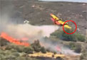 CL-215 water bomber's wing tip strikes ground after water drop