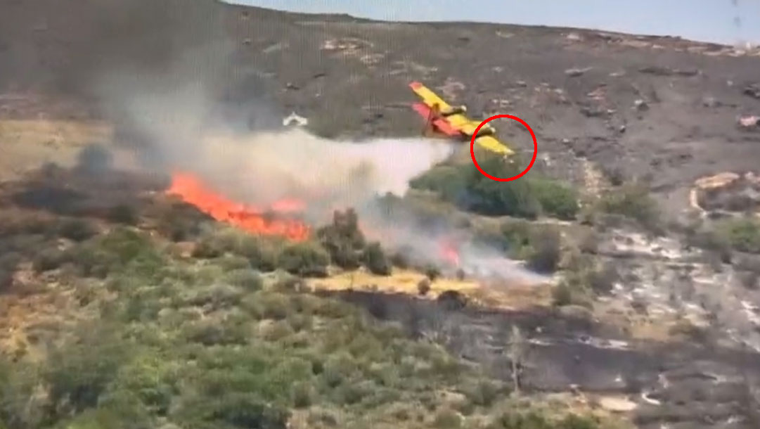 CL-215 water bomber's wing tip strikes ground after water drop