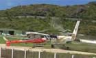 The Air Antilles Express DHC-6 veers off the runway on landing and collides with a helicopter