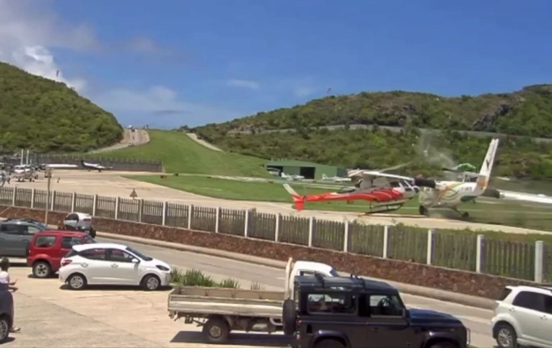 The Air Antilles Express DHC-6 veers off the runway on landing and collides with a helicopter